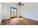 Well-lit bedroom featuring wood-look floors, sliding glass doors, and white walls at 1750 E Ocotillo Rd # 11, Phoenix, AZ 85016