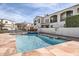 Community pool with tile waterfall feature, tanning deck, and view of the surrounding community buildings at 1750 E Ocotillo Rd # 11, Phoenix, AZ 85016