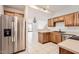 Functional kitchen space with stainless steel appliances, wood cabinets, and tile flooring at 1750 E Ocotillo Rd # 11, Phoenix, AZ 85016