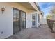 A brick-paved patio adjacent to the building featuring sliding glass doors, a door and access to an outdoor area at 1750 E Ocotillo Rd # 11, Phoenix, AZ 85016