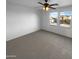 Bright, airy bedroom featuring carpet and two sunny windows at 17699 W Tonto St, Goodyear, AZ 85338