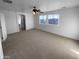 Large bonus room featuring carpet flooring and natural light, ideal for entertaining or relaxing at 17699 W Tonto St, Goodyear, AZ 85338