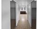 Hallway view of the full bathroom and its vanity with a framed mirror, accessible by sliding doors at 17699 W Tonto St, Goodyear, AZ 85338