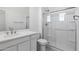 Clean bathroom features a shower and single sink vanity with grey tile flooring at 17712 W Hatcher Rd, Waddell, AZ 85355