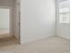 Bedroom with neutral carpet, light walls, and connecting doorway at 17712 W Hatcher Rd, Waddell, AZ 85355