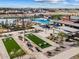 A dynamic view featuring bocce ball courts, pool and splash pad, playground, and barbecue ramada at 17729 W Amber Dr, Goodyear, AZ 85338