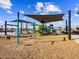 Community playground with swings, slides, and climbing structures, with shaded seating areas for families at 17729 W Amber Dr, Goodyear, AZ 85338