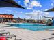 Community pool area with shaded seating and a colorful splash pad for on a sunny day at 17729 W Amber Dr, Goodyear, AZ 85338