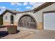 Close-up of a home's courtyard featuring desert landscaping and an arched entrance at 1812 W Curry Drive Dr, Chandler, AZ 85224