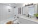 Bathroom with tub, white tiling and a vanity sink at 18811 N 19Th Ave # 2025, Phoenix, AZ 85027