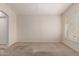 A sunlit bedroom featuring tan carpet, white walls, and large windows with shutters at 19802 N Greenview Dr, Sun City West, AZ 85375