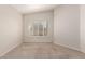 A bedroom featuring tan carpet, white walls, a ceiling fan, and large windows with shutters at 19802 N Greenview Dr, Sun City West, AZ 85375