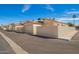 View of home exteriors, featuring driveways, block walls and desert landscaping at 19802 N Greenview Dr, Sun City West, AZ 85375