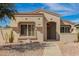 Charming single-story home with desert landscaping and neutral color palette under a sunny, blue sky at 19802 N Greenview Dr, Sun City West, AZ 85375