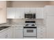 A kitchen featuring white cabinets, marble countertops, and stainless steel appliances at 19802 N Greenview Dr, Sun City West, AZ 85375