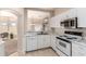 Efficient kitchen with white cabinets, marble countertops, and stainless steel appliances at 19802 N Greenview Dr, Sun City West, AZ 85375