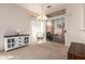 Open-concept living area featuring neutral tones, a chandelier, and sliding glass doors to the outside at 19802 N Greenview Dr, Sun City West, AZ 85375