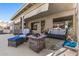 Covered patio with wicker furniture and fire pit provides plenty of space to relax outdoors at 19930 N 98Th Ave, Peoria, AZ 85382