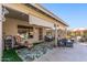 A covered patio includes outdoor seating, decor, and a beautiful leafy green rug at 19930 N 98Th Ave, Peoria, AZ 85382