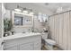 A stylish bathroom featuring a white vanity, decorative mirror, and tub shower at 19930 N 98Th Ave, Peoria, AZ 85382