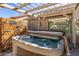 Inviting backyard hot tub perfect for relaxation with pergola shade at 19930 N 98Th Ave, Peoria, AZ 85382