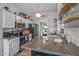 Galley kitchen with stainless steel appliances, open shelving and subway tile backsplash at 19930 N 98Th Ave, Peoria, AZ 85382