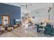 Bright living room with dark blue accent wall, wood floors, and comfortable seating at 19930 N 98Th Ave, Peoria, AZ 85382