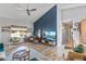 Bright living room featuring a vaulted ceiling, accent wall, and luxury vinyl plank flooring at 19930 N 98Th Ave, Peoria, AZ 85382