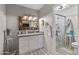 This is the main bath, featuring a decorative mirror, white vanity, and glass enclosed shower at 19930 N 98Th Ave, Peoria, AZ 85382