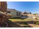 Well-maintained backyard features a pool, lush lawn and decorative landscaping at 221 N 151St Ave, Goodyear, AZ 85338