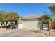 Attractive home with a neutral color scheme, tiled roof, and tidy landscaping at 221 N 151St Ave, Goodyear, AZ 85338