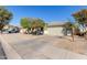 A cozy house with manicured desert landscaping and a paved driveway at 221 N 151St Ave, Goodyear, AZ 85338