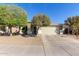 Charming single-story home with a two-car garage and mature trees at 221 N 151St Ave, Goodyear, AZ 85338