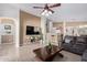 Bright living room featuring tile floors, a comfortable sofa, and an entertainment center at 221 N 151St Ave, Goodyear, AZ 85338