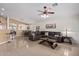 Open-concept living room with a comfortable sofa, tile flooring, and view into the dining area at 221 N 151St Ave, Goodyear, AZ 85338