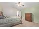 Comfortable main bedroom with carpet, wooden furniture, and a ceiling fan at 221 N 151St Ave, Goodyear, AZ 85338