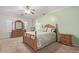 Inviting main bedroom with a wooden bed frame, carpet flooring, and a ceiling fan at 221 N 151St Ave, Goodyear, AZ 85338