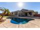 A sparkling backyard pool with a palm tree, perfect for cooling off on hot days at 221 N 151St Ave, Goodyear, AZ 85338