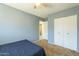 This bedroom has a ceiling fan, closet, and blue painted walls at 2338 W Lupine Ave, Phoenix, AZ 85029