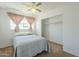 Bright bedroom featuring a ceiling fan, window with curtains, and a closet at 2338 W Lupine Ave, Phoenix, AZ 85029