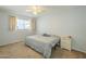 Bedroom showcasing cozy carpeting, a ceiling fan, and a bright window for natural light at 2338 W Lupine Ave, Phoenix, AZ 85029