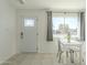 Bright entryway featuring a stylish front door, tile flooring, and a dining area with natural light at 2338 W Lupine Ave, Phoenix, AZ 85029