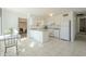 Bright, open kitchen with white cabinets, tile floors, and a cozy dining area for Gathering meals at 2338 W Lupine Ave, Phoenix, AZ 85029