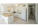 Well-lit kitchen featuring white appliances, wood countertops, and ample cabinet space for storage at 2338 W Lupine Ave, Phoenix, AZ 85029