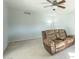 Spacious living room featuring neutral carpeting, a ceiling fan and ample empty space at 2338 W Lupine Ave, Phoenix, AZ 85029