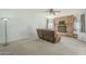 Cozy living room featuring a brick fireplace, plush carpeting, and a ceiling fan at 2338 W Lupine Ave, Phoenix, AZ 85029