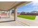 Covered patio overlooking lush green yard perfect for entertaining at 23407 W Ashleigh Marie Dr, Buckeye, AZ 85326