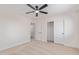 Bright bedroom with neutral carpet, ceiling fan and closet space at 23407 W Ashleigh Marie Dr, Buckeye, AZ 85326