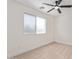 Cozy bedroom with neutral carpet, white trim, and a ceiling fan for enhanced comfort at 23407 W Ashleigh Marie Dr, Buckeye, AZ 85326