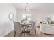 Cozy dining area featuring a modern chandelier, seating for four, and neutral decor at 23407 W Ashleigh Marie Dr, Buckeye, AZ 85326